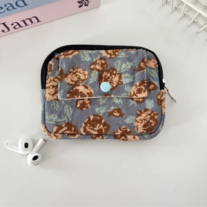 Detail of blue corduroy coin purse with brown rose prints and metal snap pocket
