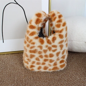 Detail of plush faux fur handbag with giraffe print and check fabric lining