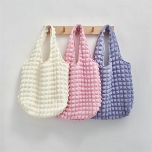 Detailed close-up of bubble textured floral tote bags in cream pink and lavender purple