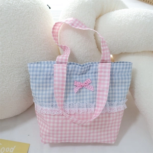 Detailed shot of sweet blue and pink checkered handbag with lace trim and bow accent