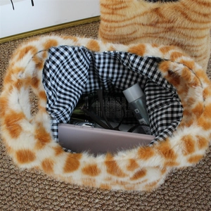 Top view of plush giraffe print handbag showing interior storage and checkered lining