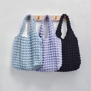 Detailed bubble texture on shoulder bags in blue, purple, and black polyester