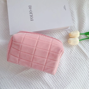 Pink checkered velvet makeup bag with soft quilted texture and smooth zipper closure