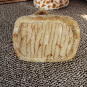Macro detail of soft faux fur texture with animal leopard pattern on fashionable handbag