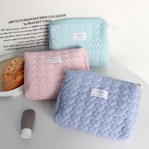 Detailed view of quilted heart pattern and stripes on soft fabric cosmetic bags
