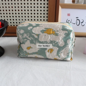 Close-up of May Rabbit jacquard pencil case with green floral texture and metal zipper