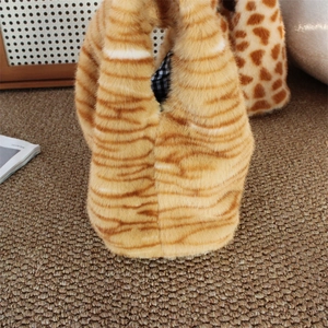 Close-up of plush faux fur handbag with orange tiger stripes and checkered lining