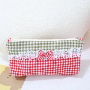 Detailed shot of a plaid cosmetic bag with lace ribbon and heart-shaped metal zipper pull