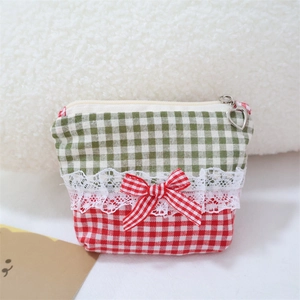 Detailed view of lace trim and gingham bow on the sweet fabric cosmetic handbag