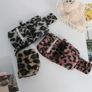 Detailed view of plush leopard print coin purses in pink, grey and brown colors