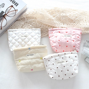 Quilted makeup pouches set featuring floral and heart patterns with metal zippers