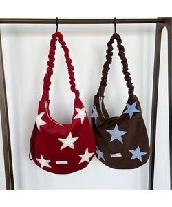 Detail of star patchwork wool shoulder bags with ruched adjustable cloud straps
