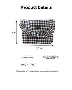 Close-up of checkered fabric mini storage bag with ruffled trim and snap button