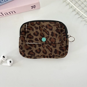 Detail of leopard print corduroy pouch with turquoise button and metal hook