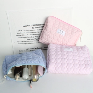 Quilted heart cosmetic bags set including pink and lilac heart patterns with zippers