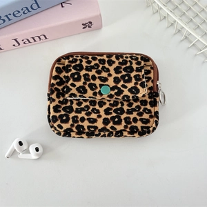 Close-up of leopard print corduroy pouch showing zipper detail and mint green button