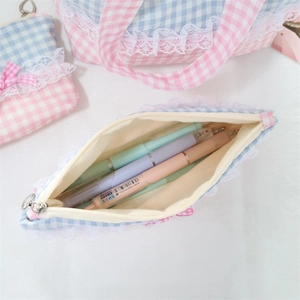 Detailed interior view of a lace-trimmed plaid makeup bag showing large storage capacity