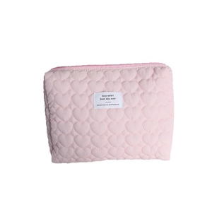 Quilted heart pattern makeup bag in soft pink with top zipper closure and label