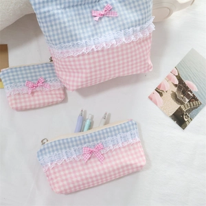 Detail of sweet blue pink plaid cosmetic bags with lace trims and cute bow accents