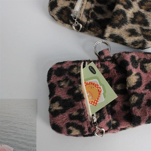 Close-up of leopard print plush coin purse with heart zipper and silver metal clasp
