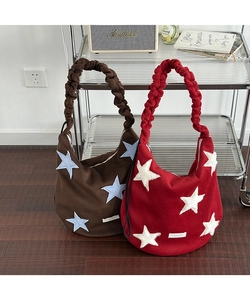 Detail of wool star tote bag with pleated adjustable straps in brown and red
