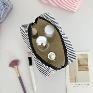 Seersucker striped travel makeup bag with large capacity and smooth zipper closure
