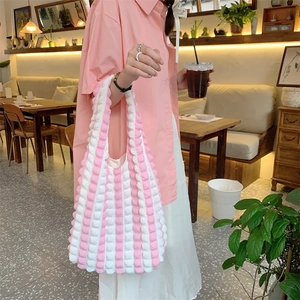 Detail of pink and white bubble texture fabric on a stylish shoulder tote bag
