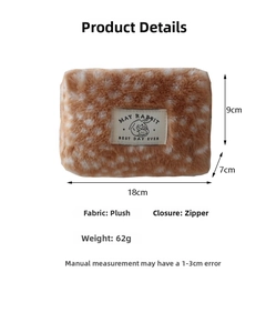 Detail view of plush deer pattern makeup pouch showing 18x9x7cm size and soft texture