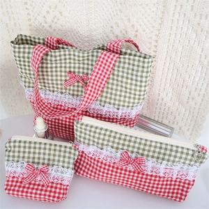 Detailed set of three red plaid makeup bags with lace trim and heart charm zippers