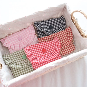 Detailed view of ruffle-edged gingham mini pouches in five assorted colors in a basket