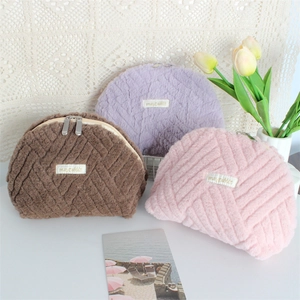 Plush quilted shell makeup bags in purple, brown and pink with dual metal zippers