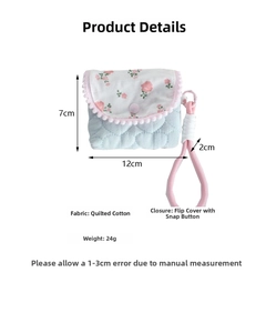 Close-up of floral quilted pencil case with wrist strap and flip-top buckle closure