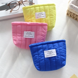 Quilted vertical stripe cosmetic bags in pastel yellow, pink, and blue by mayrabbit