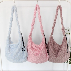 Plush leopard print hobo bags in blue and pink hanging with twisted shoulder straps