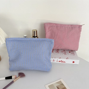 Seersucker striped makeup bags in red and blue with metal zipper and high texture finish
