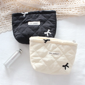 Quilted floral cosmetic bags in black and beige with elegant bow embroidery