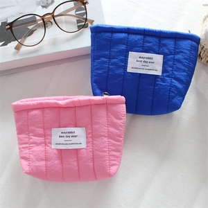 Minimalist quilted vertical stripe cosmetic pouches in pink and blue colors