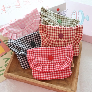 Detail showing colorful plaid ruffle pouches with a central button and Rabbit label