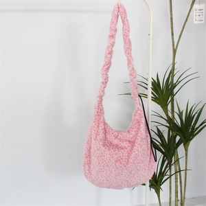 Detailed view of pink leopard and heart print plush shoulder bag with fluffy texture