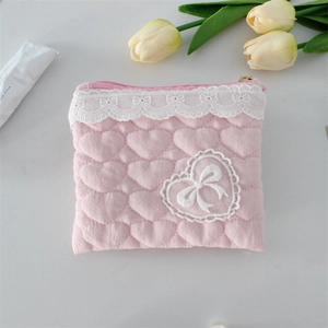 Vue détaillée de la pochette rose matelassée en cœur avec dentelle et nœud