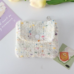 Close-up of tweed coin purse with colorful knit texture, button closure and metal ring