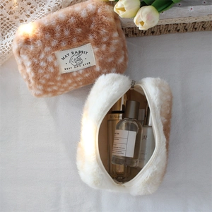 Detail view of large plush deer print cosmetic bags with metal zipper and soft texture
