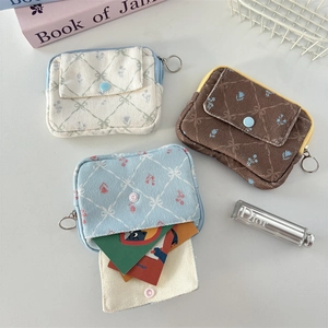 Floral corduroy card holders and coin purses in beige, brown, and light blue colors
