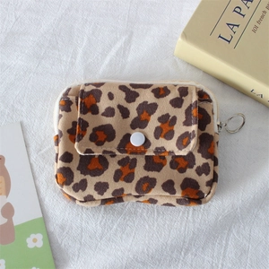 Detail of leopard print corduroy wallet with resin snap button and silver ring zipper
