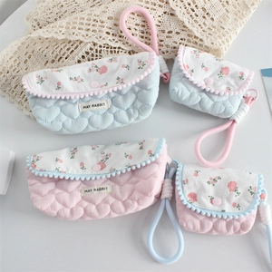 Quilted floral pencil cases with heart stitching and rose patterns in pink and blue
