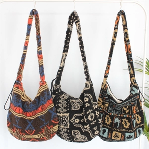 Detailed view of bohemian style plush tote bags with ethnic geometric patterns on hangers