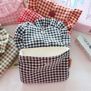 Detail of four-color plaid mini storage bags with ruffled edges and metal snap closure