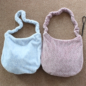 Detail of light blue and lavender faux fur leopard print shoulder bags with ruched straps