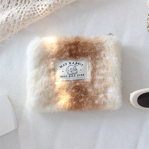 Detail of deer pattern plush coin purse with May Rabbit woven label and soft fur texture