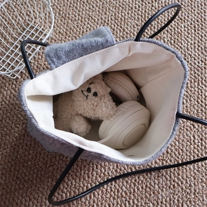 Top view of spacious grey plush tote bag interior with soft lining and thin handles